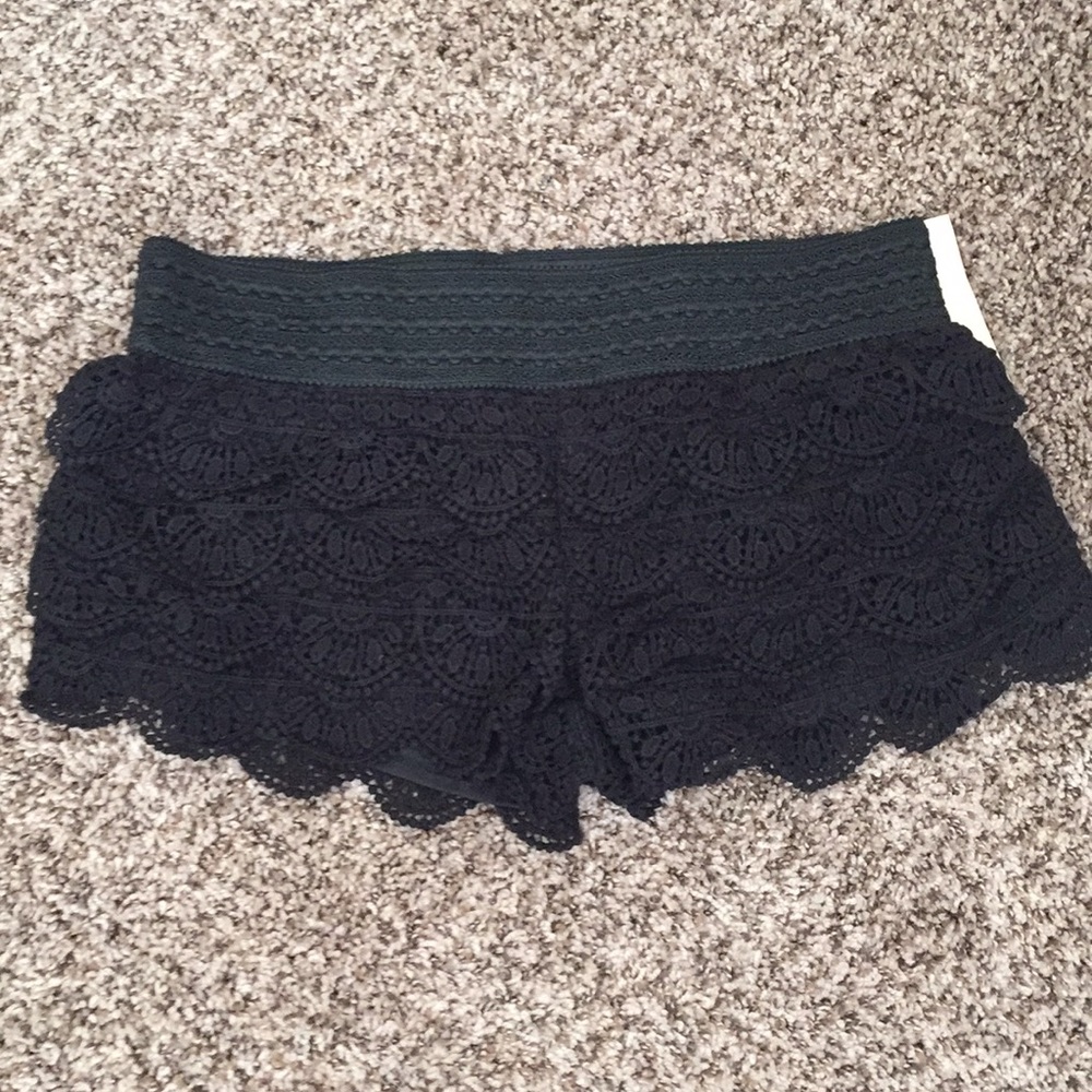 Black yarn laced shorts with ruffles.